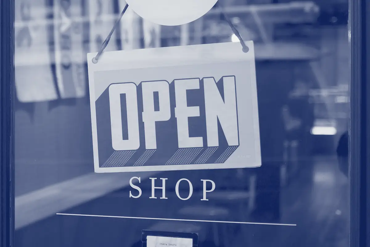 An open sign hanging in a shop door